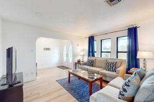 a living room with a couch and a tv at Sun & Smiles in Cape Coral