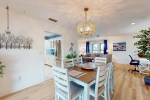 a dining room and living room with a table and chairs at Sun & Smiles in Cape Coral