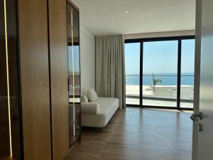 a living room with a couch and a view of the ocean at Palmera Resort Saranda - Palmera Villa Resort in Sarandë +59 photos