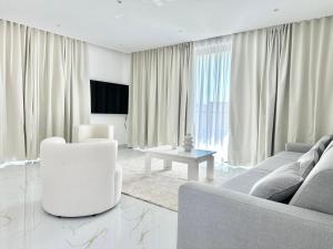 a living room with a couch and a table at Palmera Resort Saranda - Palmera Villa Resort in Sarandë