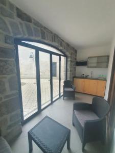a living room with a large window and a couch at Dimora Storica Apartments in Ruviano