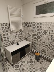 a kitchen with a tv on a tiled wall at Petite maison dans les bois in Villefranque +30 photos