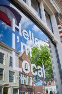 a sign in the window of a houstonitz rate therapy at Hello I'm Local - Boutique Hostel in Haarlem +8 photos