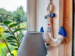 a lamp on a window sill next to a window at SeaSide Sopot - butikowe noclegi przy plaży in Sopot