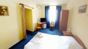 Posteľ alebo postele v izbe v ubytovaní Corvin Hotel