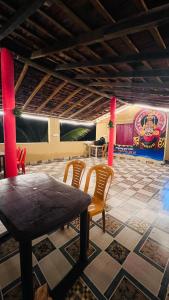 a restaurant with a table and chairs in a room at Nakshatra Beach Stay in Gokarn