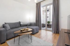 a living room with a couch and a table at Anja Apartment in Bečići