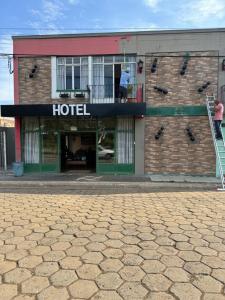 a man standing on the balcony of a hotel at Hotel Formigas na Figueira in Tibagi