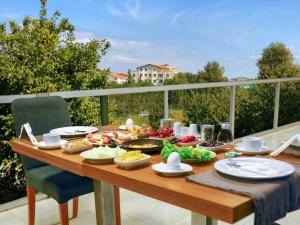 a wooden table with food on top of a balcony at Helenapolis Otel in Yalova