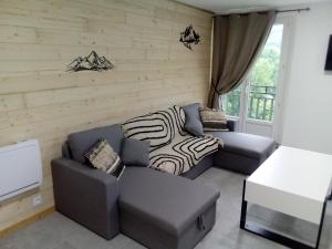 a living room with two couches and a zebra blanket at appt tout confort a laveissiere 103 in Laveissière