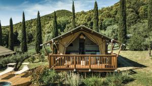 a gazebo in a garden with trees at Glamping Le Tegole in Riparbella