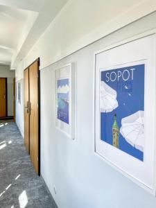 a hallway of a hospital with posters on the wall at SeaSide Sopot - butikowe noclegi przy plaży in Sopot