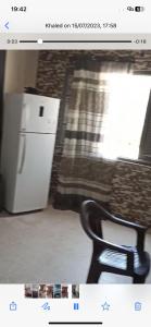 a picture of a kitchen with a chair and a refrigerator at Beach Town flat1 in Mazer