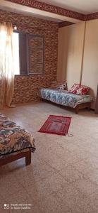 a room with two beds and a rug on the floor at Beach Town flat1 in Mazer