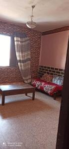 a room with a bed and a bench and a window at Beach Town flat1 in Mazer