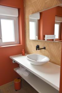 a bathroom with a white sink and a mirror at SPA rêve nature in Calais