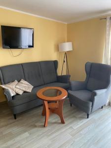 a living room with a couch and two chairs and a table at Altona in Władysławowo