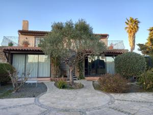 a house with a tree in front of it at Plage Miramar in La Londe-les-Maures