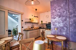 a kitchen and dining room with tables and chairs at Casa Lagomaggio in Rimini