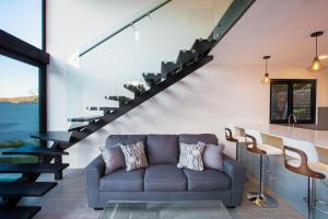 a living room with a couch and a staircase at Trendy Loft House - Private Pool - Ocean View - Santa Cruz in San Juan del Sur