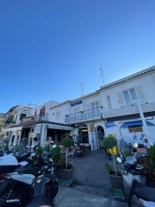 a row of motorcycles parked in front of buildings at Al Capitello in Lacco Ameno