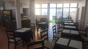 a row of tables and chairs in a restaurant at Alojamento Central II in Funchal