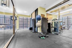 a gym with a bunch of equipment in a room at Estate 1 Bedroom Condo Front Street West in Toronto