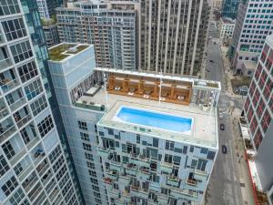 an overhead view of a building with a swimming pool at Estate 1 Bedroom Condo Front Street West in Toronto