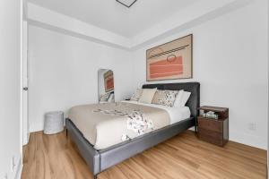 a bedroom with a bed and a wooden floor at Estate 1 Bedroom Condo Front Street West in Toronto +13 photos
