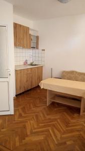 a kitchen with wooden floors and a table in a room at Despina in Nesebar