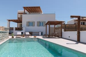 a villa with a swimming pool and a house at Velonis Villa with private pool and sea view in Agia Anna Naxos