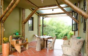 a patio with a table and chairs in a building at Charming Coffee Region Farm Escape in Armenia