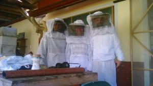 three people dressed in white standing next to a wall at Charming Coffee Region Farm Escape in Armenia