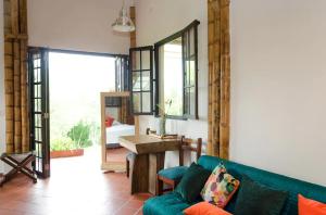 a living room with a couch and a table at Charming Coffee Region Farm Escape in Armenia
