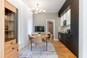 a kitchen and dining room with a table and chairs at 2BR 95m2 apartment in Old Town with Free Parking and Sauna! in Tallinn +25 photos