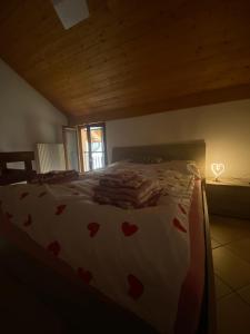 a bedroom with a bed with hearts on it at Love Stay BELLINZONA in Bellinzona