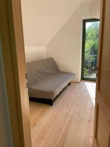 a bedroom with a bed in the corner of a room at Dom pod brzozami in Kierwik