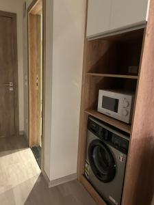 a kitchen with a microwave and a washing machine at Cozy Homes in Cairo +10 photos