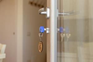 a door latch with a key on a glass door at Il Trullo di Pozzallegro in Locorotondo +16 photos