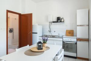 a kitchen with a table with a hat on it at Apartments Ivica in Primošten