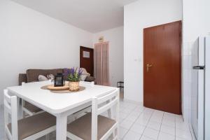a living room with a white table and a couch at Apartments Ivica in Primošten +238 photos