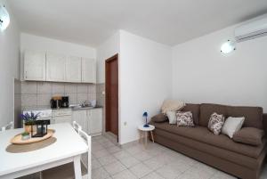 a living room with a couch and a kitchen at Apartments Ivica in Primošten