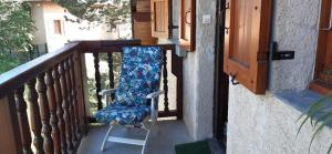 a chair sitting on the porch of a house at Studio Résidence Val d'Escreins in Guillestre +3 photos