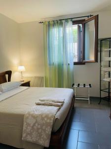 a bedroom with a large bed and a window at La Casa di Pino in Agerola