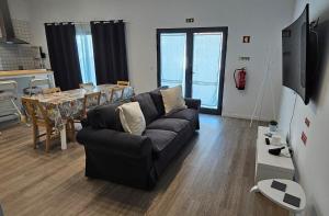 a living room with a couch and a table at Refúgio da Ilha in Ponta Delgada