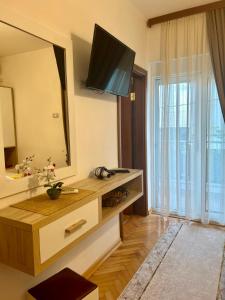 a living room with a large mirror and a television at Apartments Gazi in Ulcinj