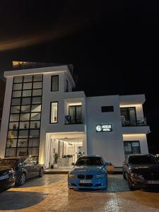 a car parked in a parking lot in front of a building at Adele Hotel Ksamil in Ksamil