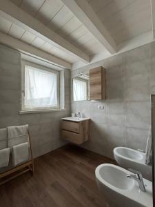 a bathroom with two sinks and a mirror at Appartamenti Lilia - Ledro in Tiarno di Sopra