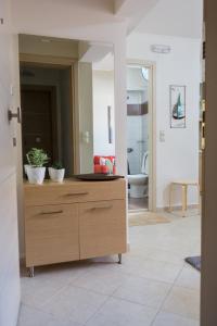 a living room with a wooden dresser in a room at Filora Apartment in the city center in Heraklio Town