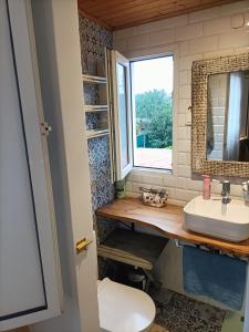 a bathroom with a sink and a window at A casa de Flora in Noya +26 photos